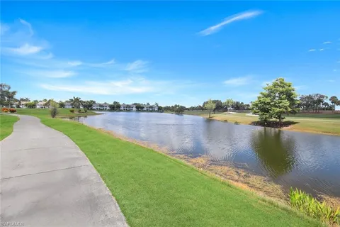 a view of a lake with houses in the back