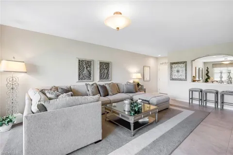 a living room with furniture and a lamp