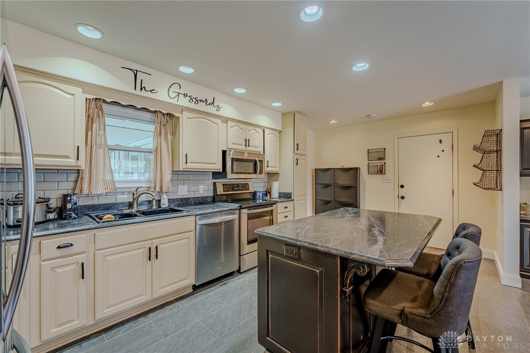 305 South Vandemark Road Sidney, OH 45365 - Photo 17 of 32 This functional kitchen features stainless steel appliances and an island, ideal for cooking and casual dining.