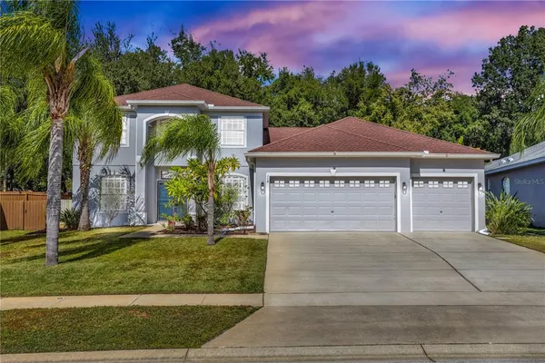 a front view of a house with a yard and garage