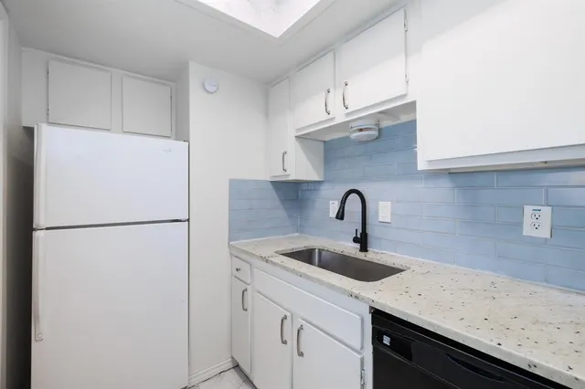 a kitchen with a sink and a refrigerator