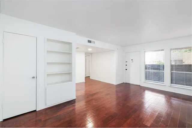 a view of wooden floor and windows in a room