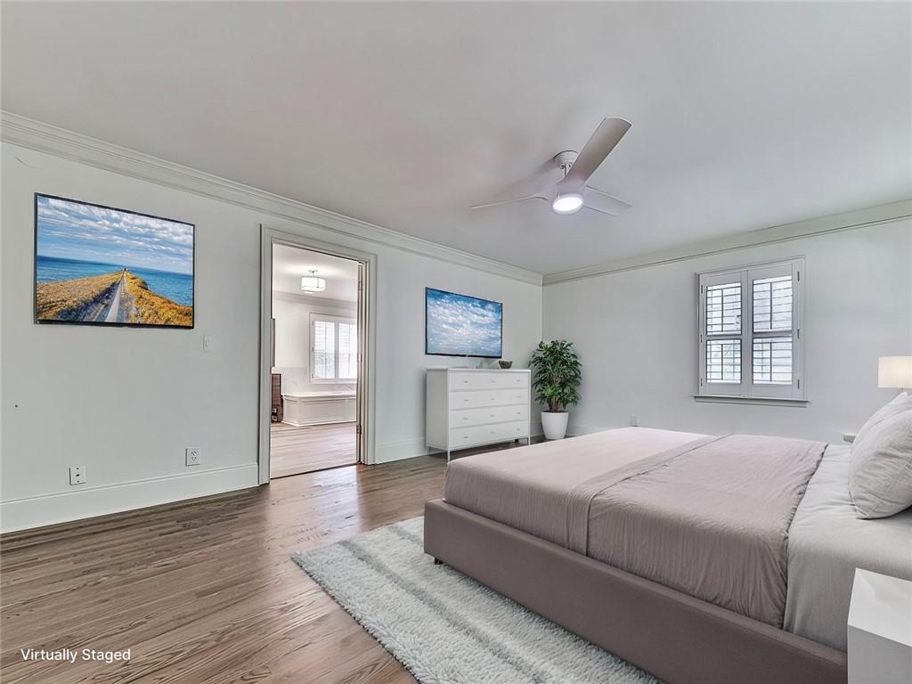 633 Butterworth Road Canton, GA 30114 - Photo 23 of 55 a spacious bedroom with a large bed a chandelier and windows