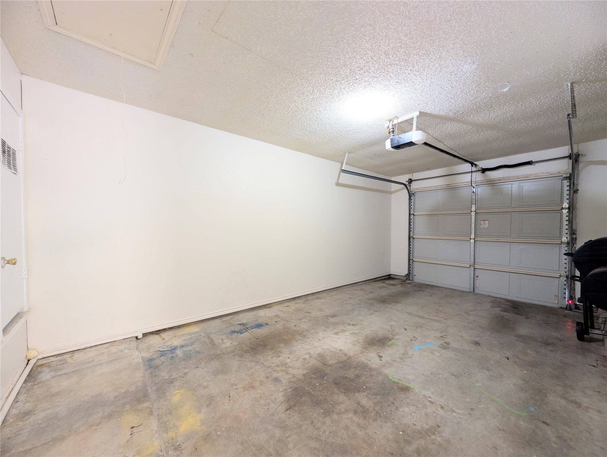 2036 Redwing Way Round Rock, TX 78664 - Photo 20 of 23 A well-lit garage with concrete flooring offers ample space and a convenient garage door opener.