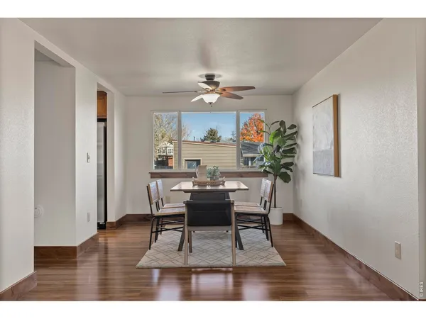 a dining room with furniture a rug and a chandelier