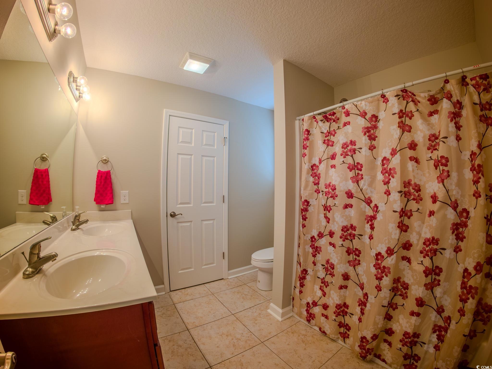 788 Rambler Court Myrtle Beach, SC 29588 - Photo 15 of 17 Full bathroom featuring a textured ceiling, tile p