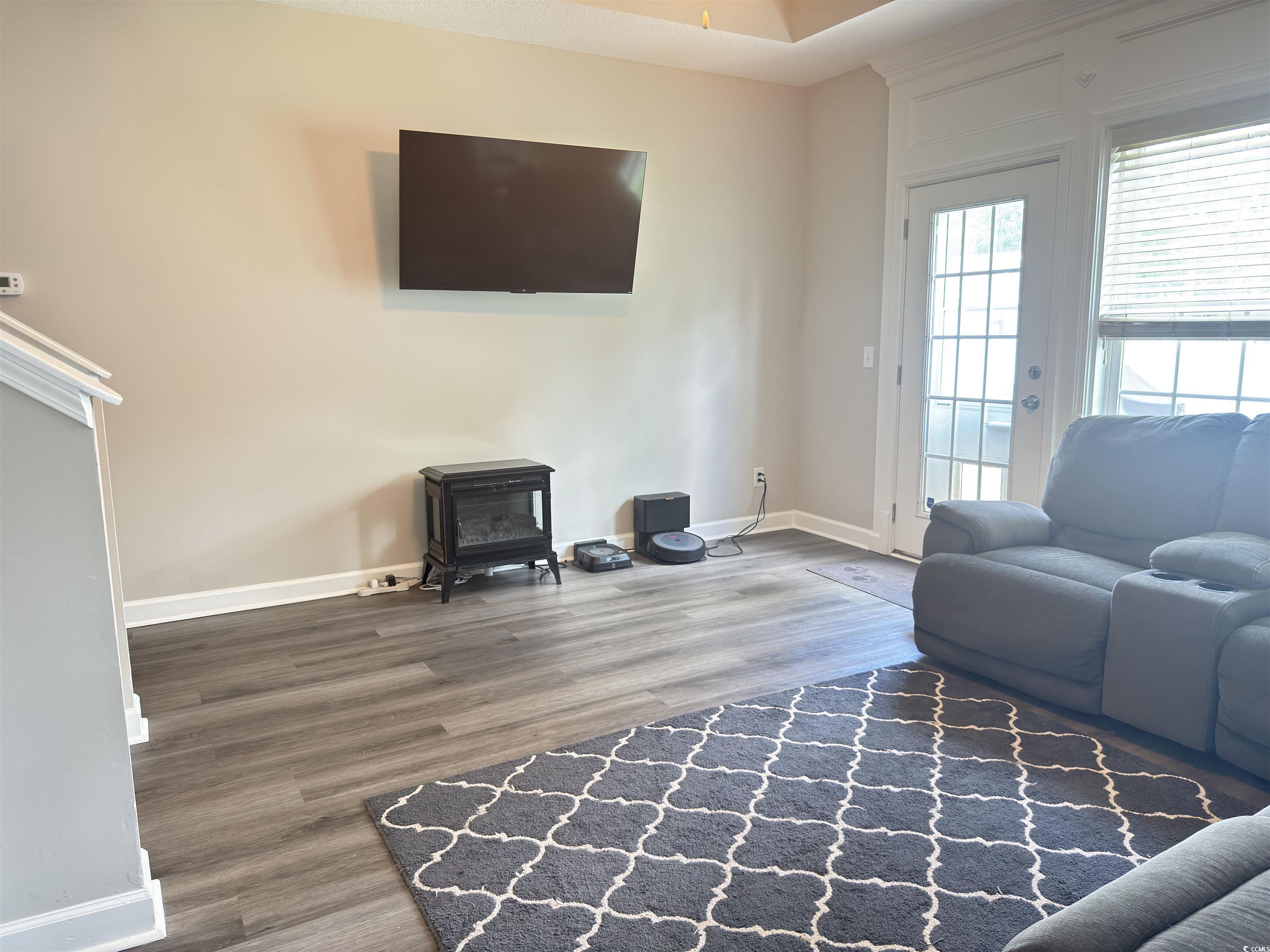 788 Rambler Court Myrtle Beach, SC 29588 - Photo 9 of 17 Living area with a wood stove and wood finished fl