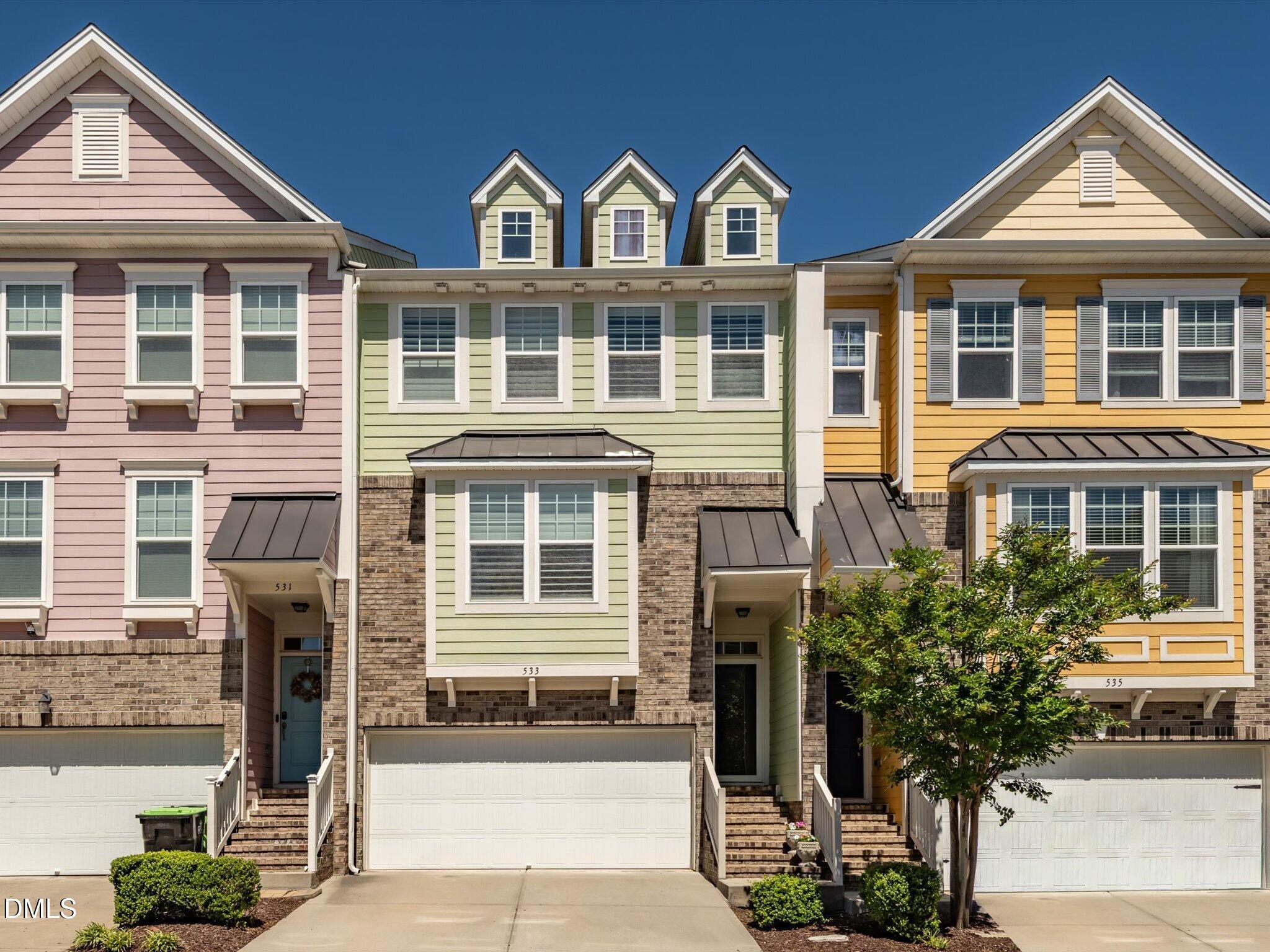 a front view of a residential houses with yard