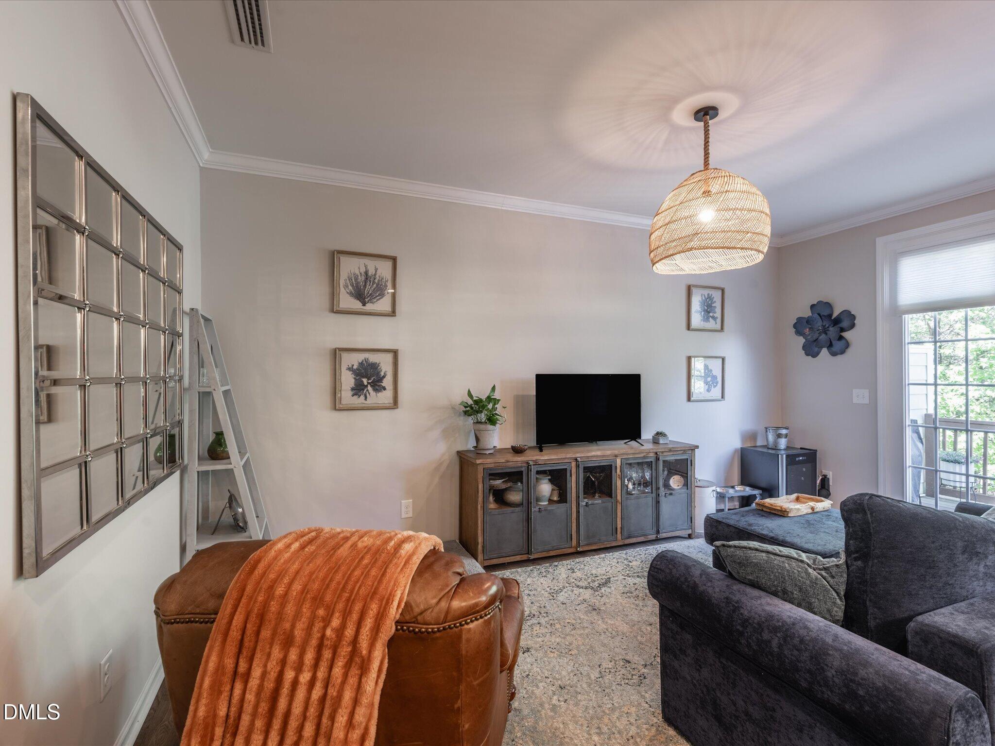 533 Metro Station Apex, NC 27502 - Photo 14 of 45 a living room with furniture and a flat screen tv