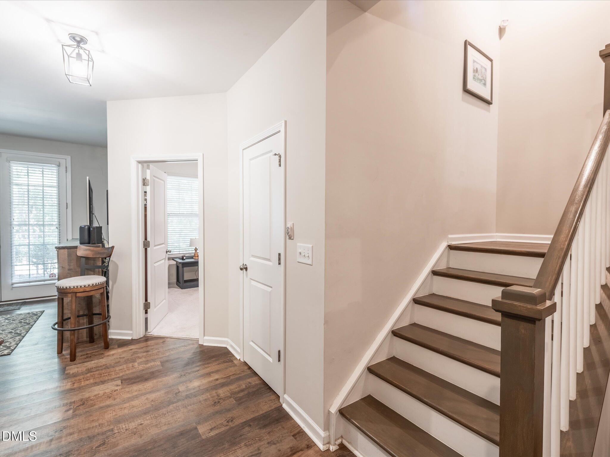 533 Metro Station Apex, NC 27502 - Photo 19 of 45 a view of a hallway with wooden floor and staircase