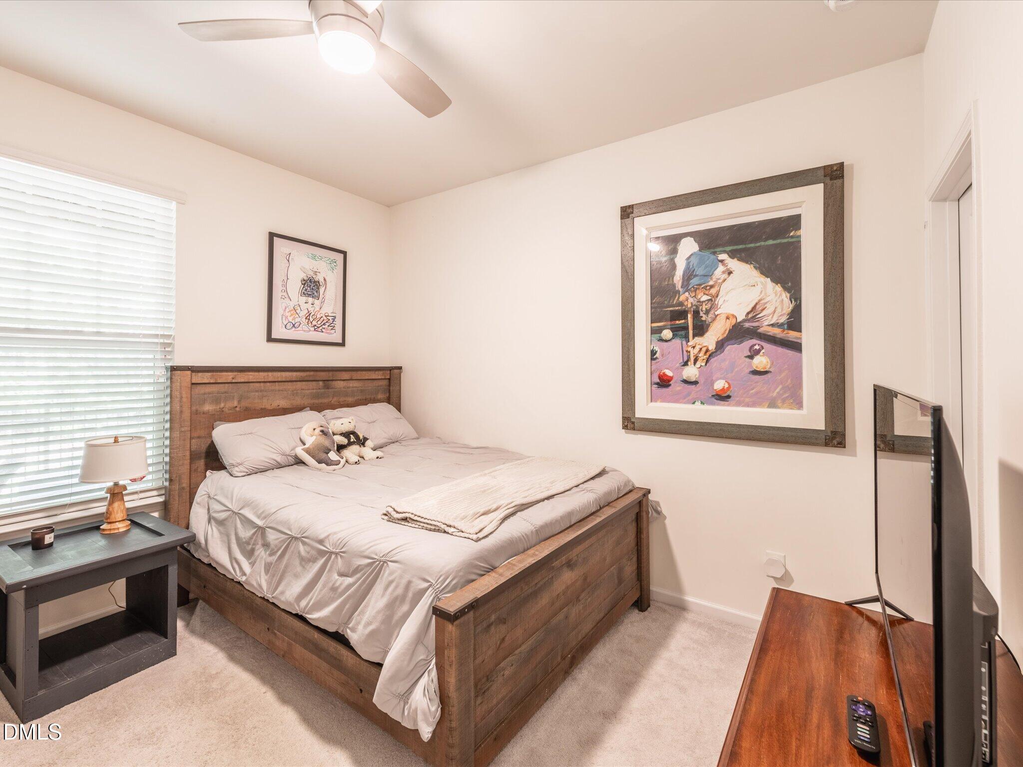 533 Metro Station Apex, NC 27502 - Photo 24 of 45 a bedroom with bed and painting on the wall