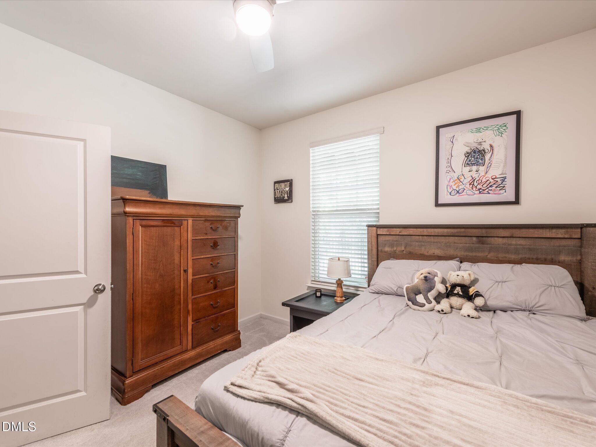 533 Metro Station Apex, NC 27502 - Photo 25 of 45 a bedroom with a large bed and a dresser