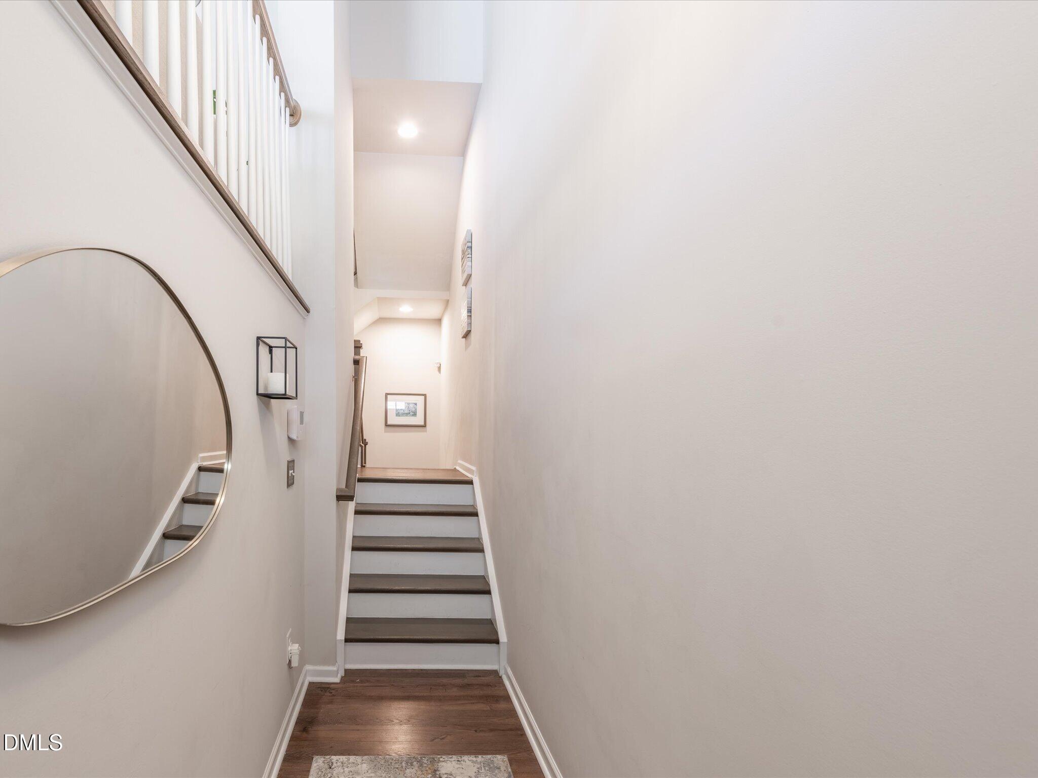 533 Metro Station Apex, NC 27502 - Photo 27 of 45 a view of staircase with wooden floor and white walls