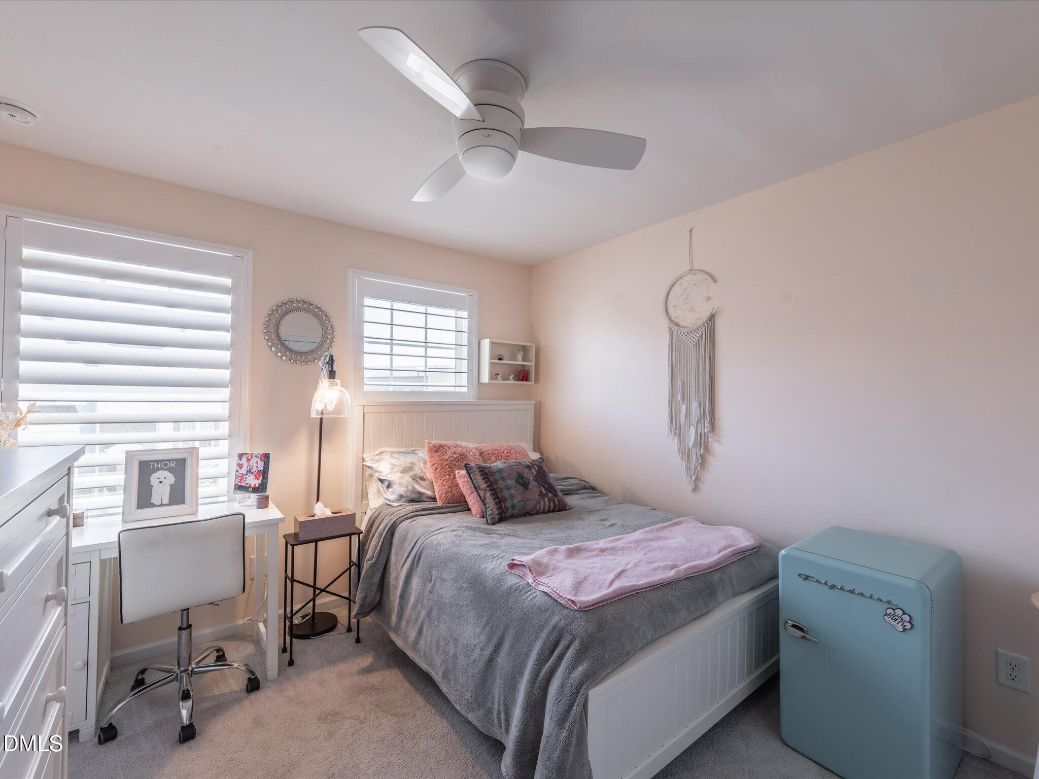 533 Metro Station Apex, NC 27502 - Photo 31 of 45 a bedroom with a bed and a chandelier