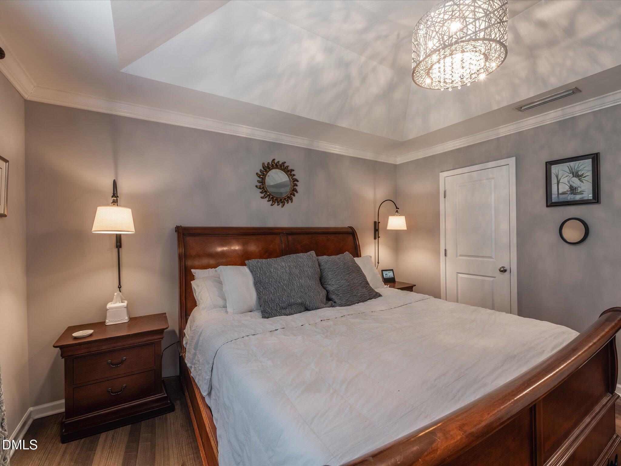 533 Metro Station Apex, NC 27502 - Photo 33 of 45 a bedroom with a bed and a lamp on table
