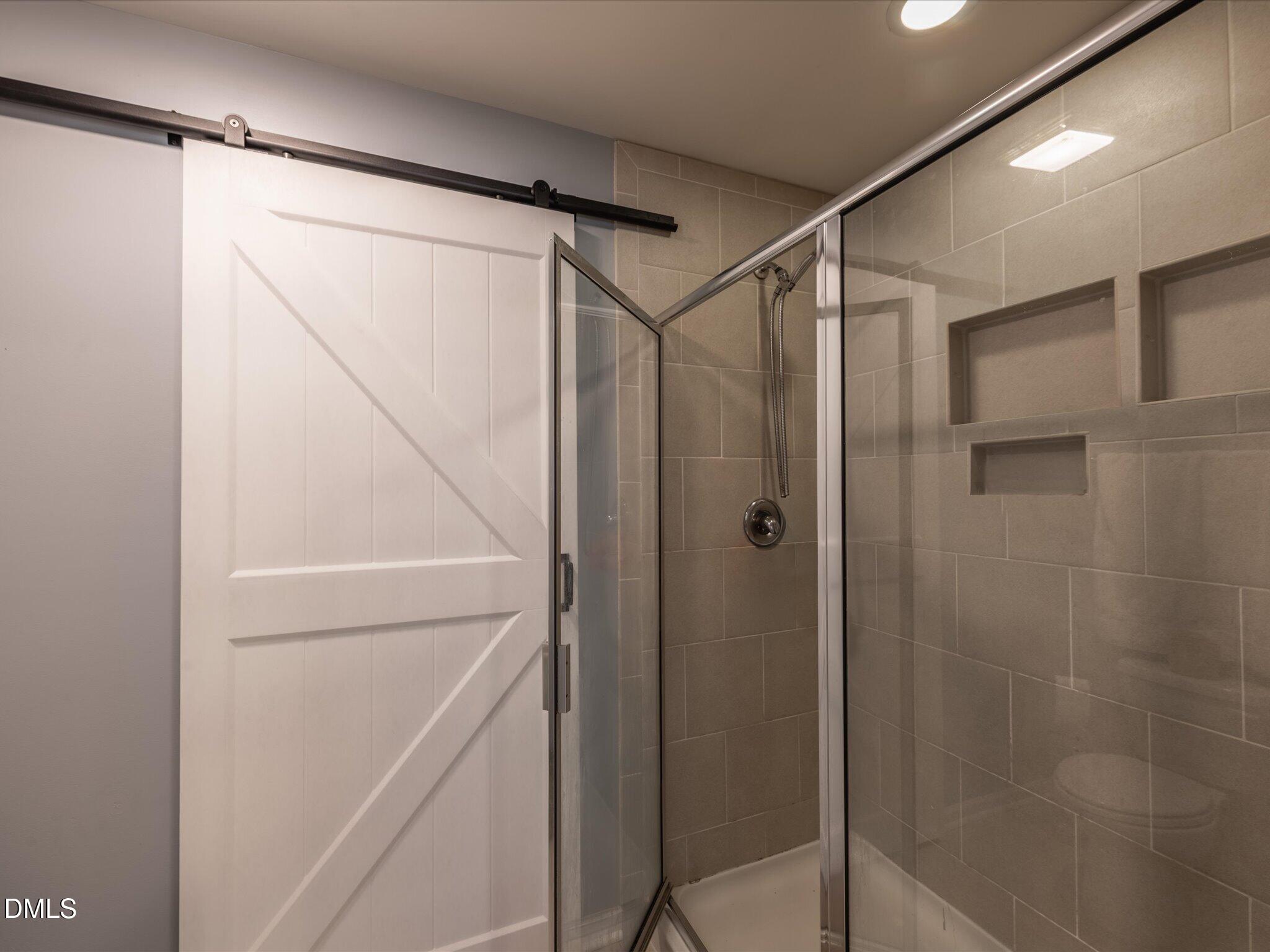 533 Metro Station Apex, NC 27502 - Photo 37 of 45 a bathroom with a shower and a glass door