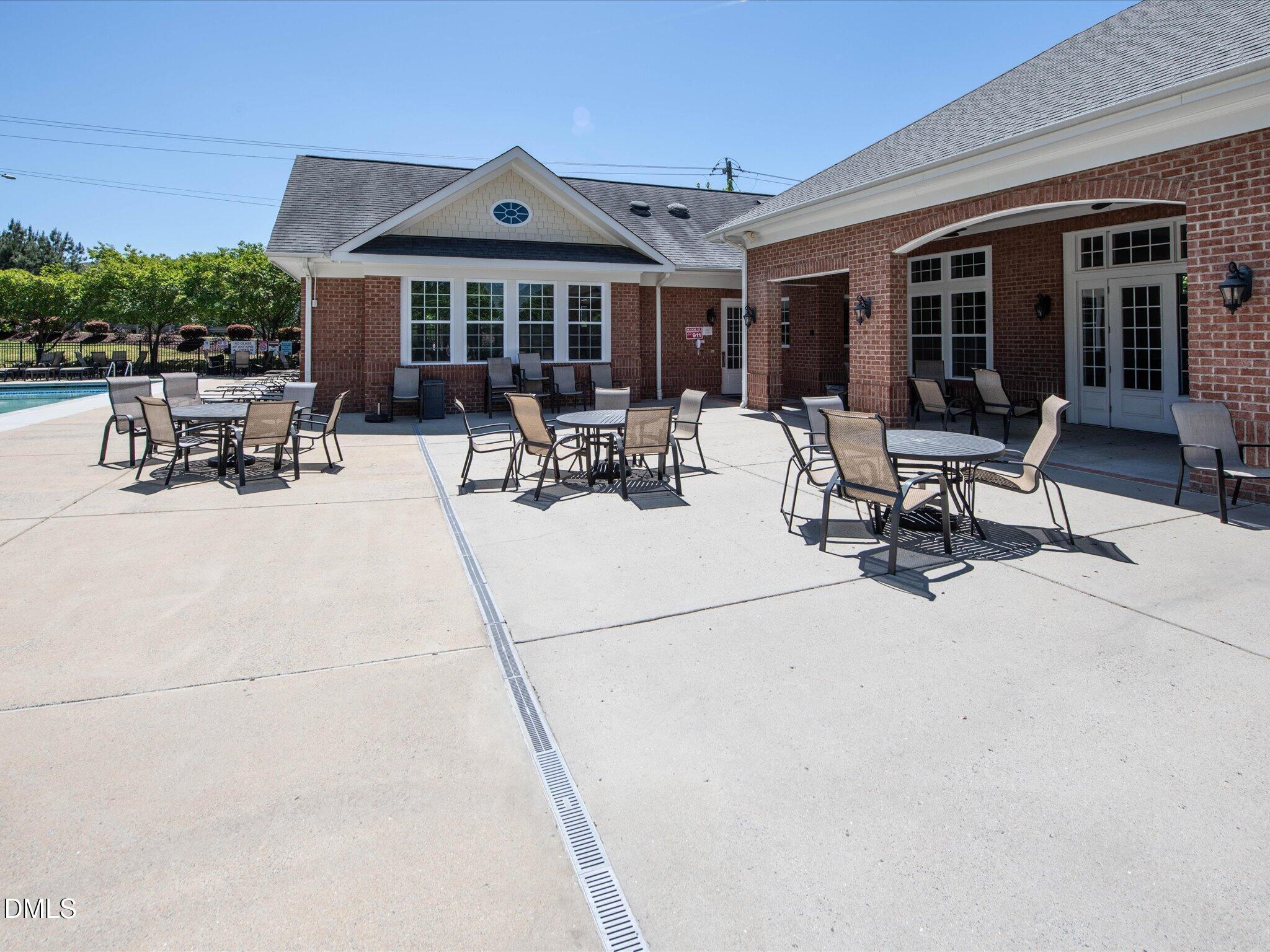 533 Metro Station Apex, NC 27502 - Photo 42 of 45 a view of a patio with dining table and chairs under an umbrella