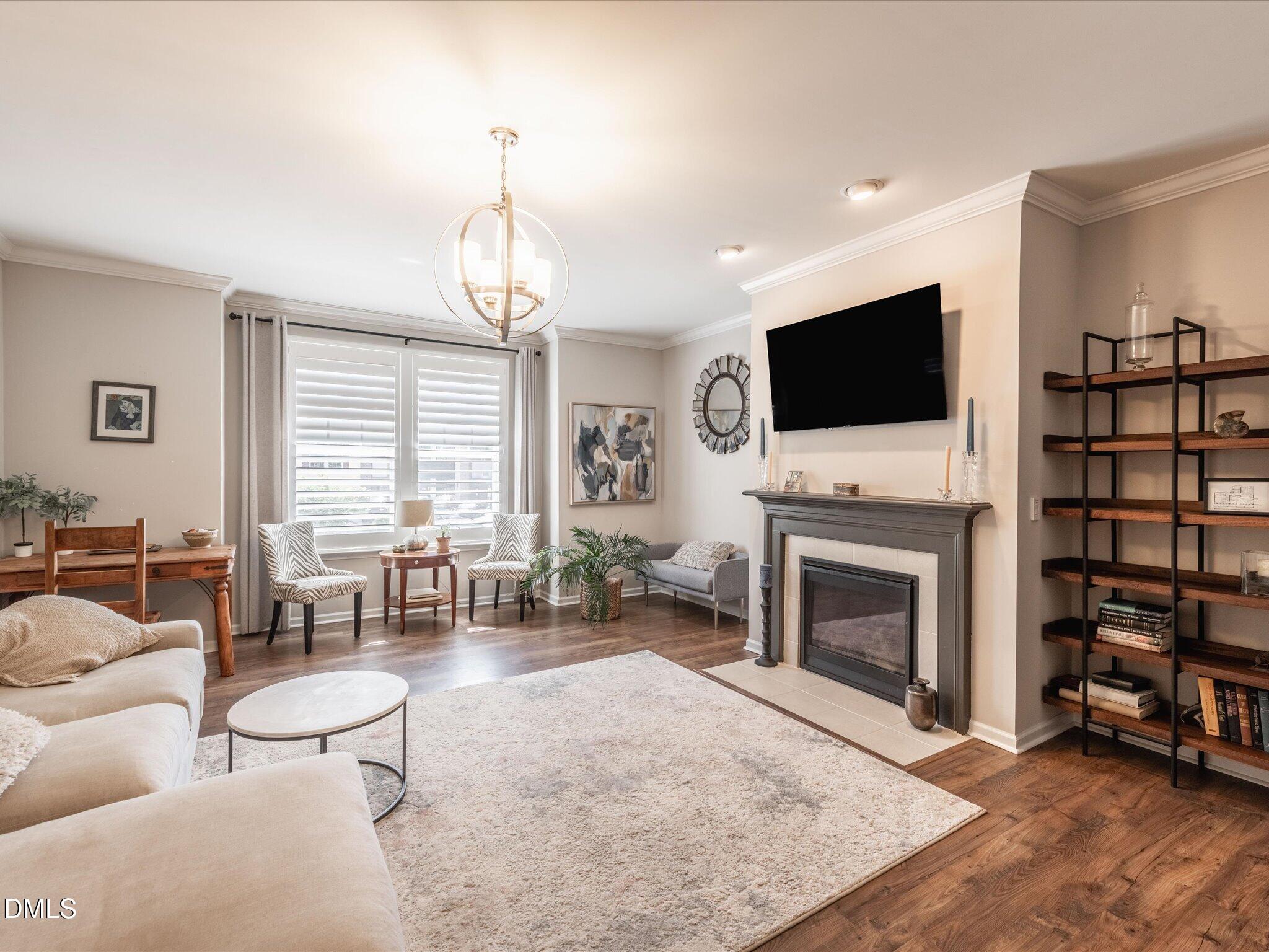 533 Metro Station Apex, NC 27502 - Photo 5 of 45 a living room with furniture a fireplace and a flat screen tv