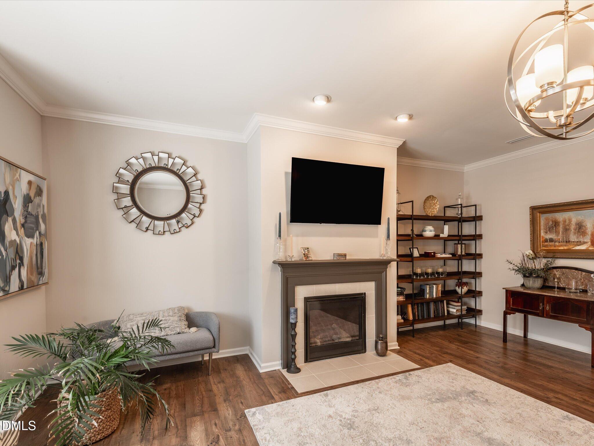 533 Metro Station Apex, NC 27502 - Photo 7 of 45 a living room with furniture a fireplace and a flat screen tv