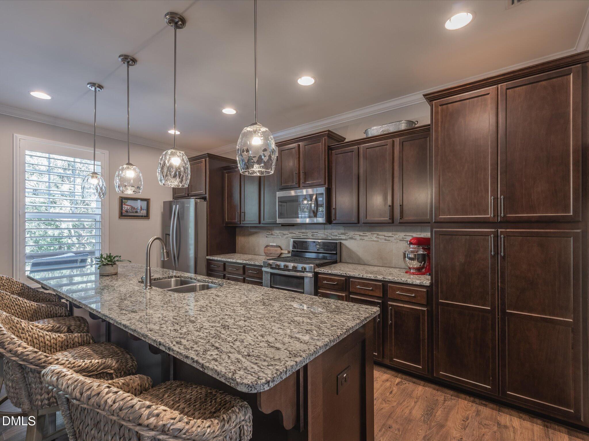 533 Metro Station Apex, NC 27502 - Photo 9 of 45 a kitchen with center island and stainless steel appliances