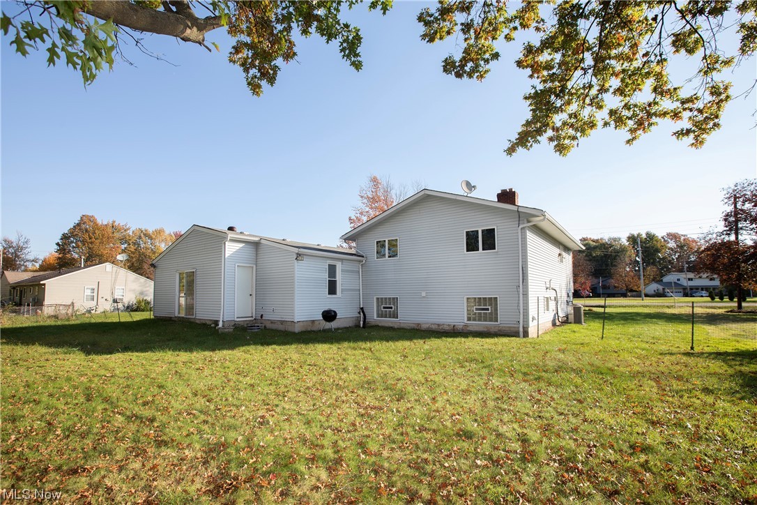 9030 Reed Road North Ridgeville, OH 44039 - Photo 32 of 35 Rear view of house featuring a yard