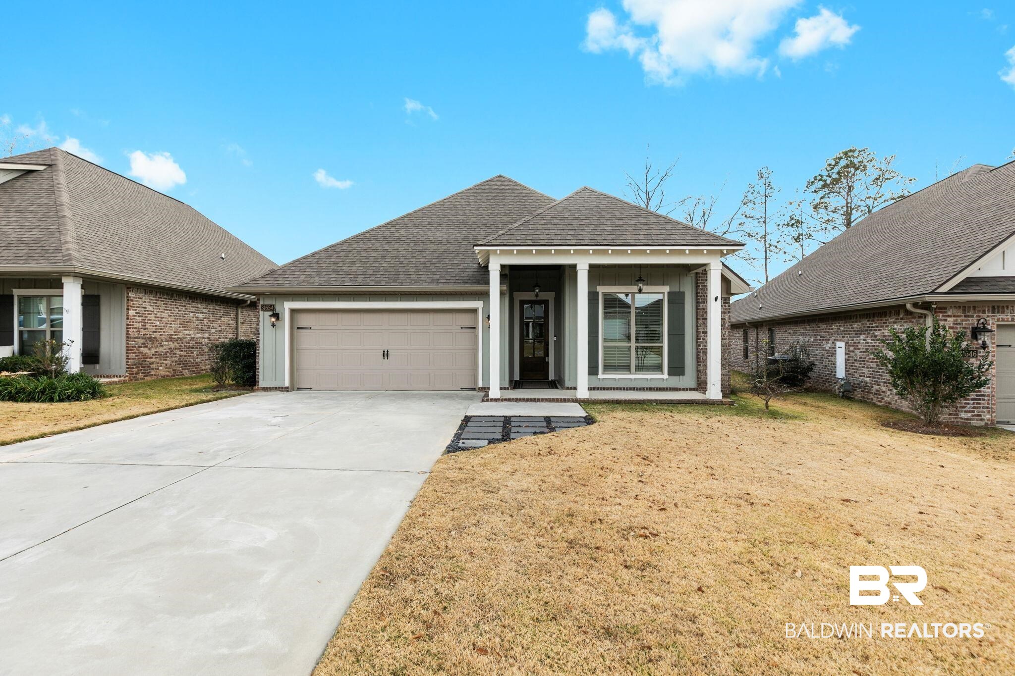 31654 Canopy Loop Daphne, AL 36527 - Photo 2 of 64 View of front of property featuring roof with shingles, brick siding, an attached garage, driveway, and a front yard