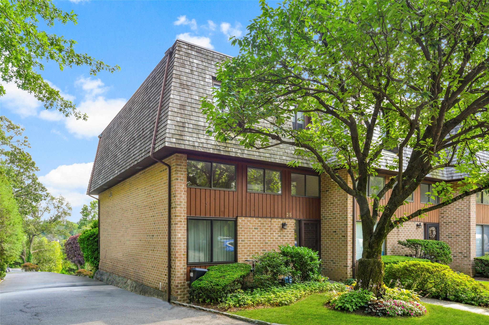 a front view of a house with garden