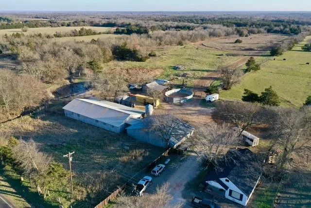 an aerial view of a house with a yard