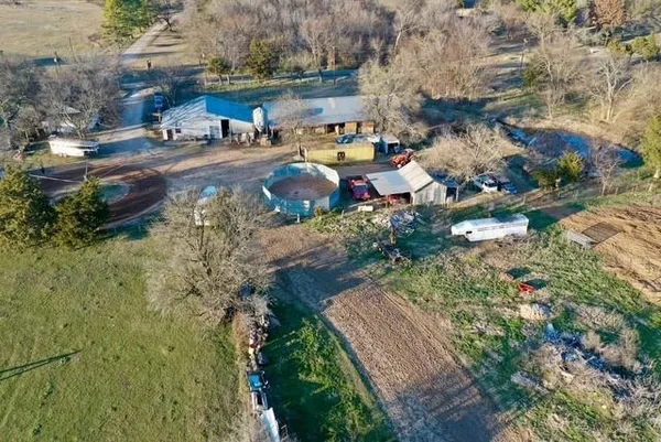 an aerial view of lake and residential houses with outdoor space