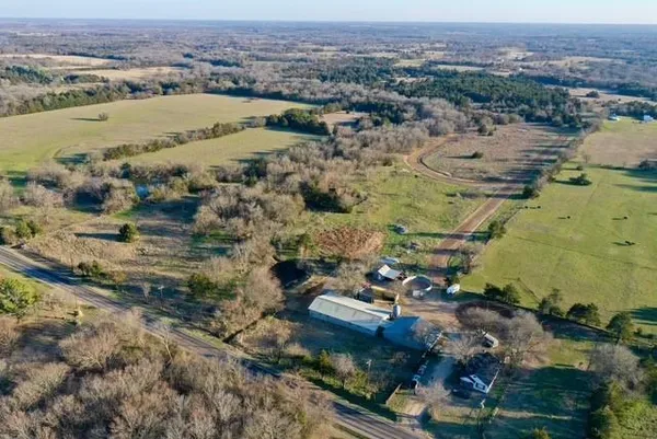 a view of a backyard with table and chairs under an umbrella
