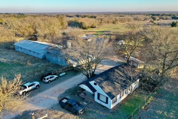 an aerial view of residential houses with outdoor space