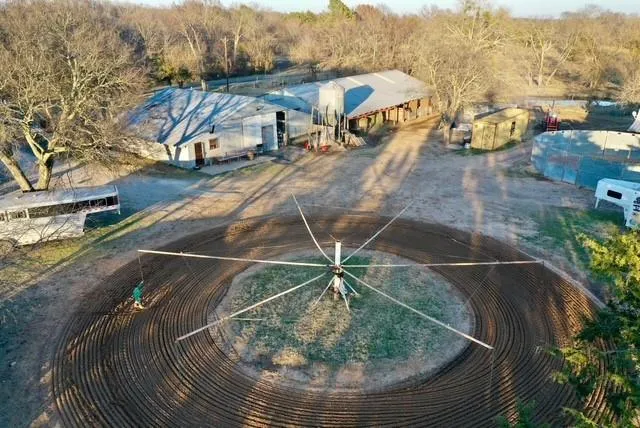 an aerial view of a house with a yard basket ball court and outdoor seating