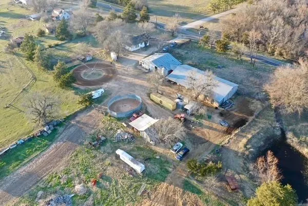 a view of a backyard with couches and wooden fence