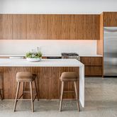 a kitchen with granite countertop a table chairs stove and refrigerator