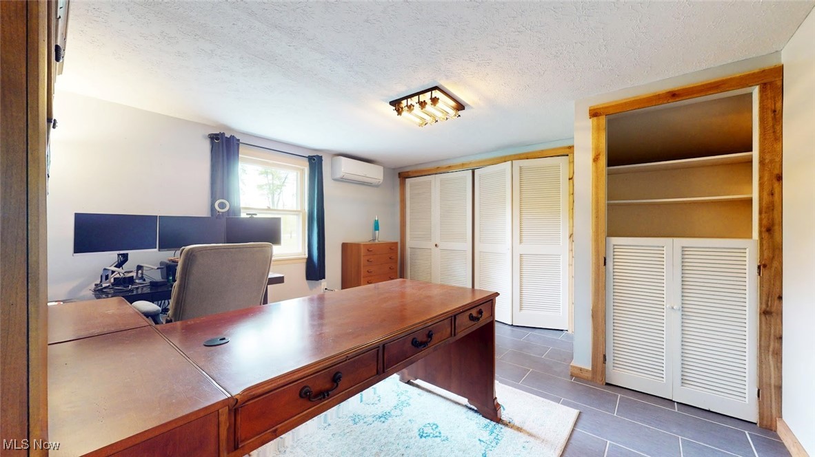 1412 Bell Road Chagrin Falls, OH 44022 - Photo 25 of 43 Tiled home office or First Floor Bedroom featuring a wall mounted AC,