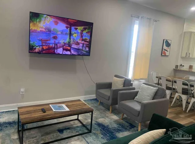 a living room with furniture a couch and a wall painting