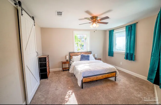 a bedroom with a bed and a window