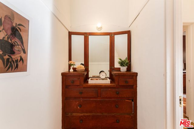 a room with a bed and large windows