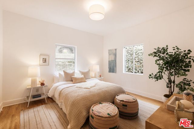 a bedroom with a bed and a potted plant