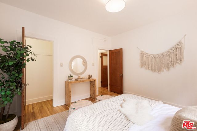 a bedroom with a bed and a potted plant