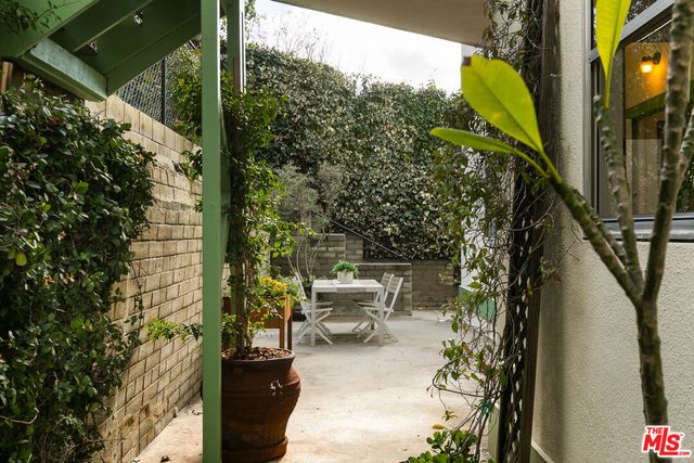 a view of a porch with chairs and table