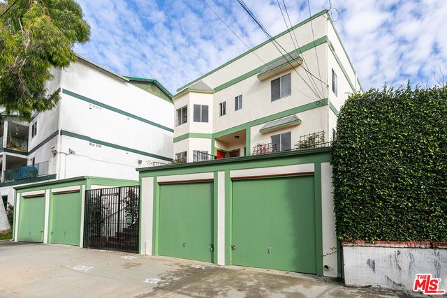 a view of a house with a garage and balcony