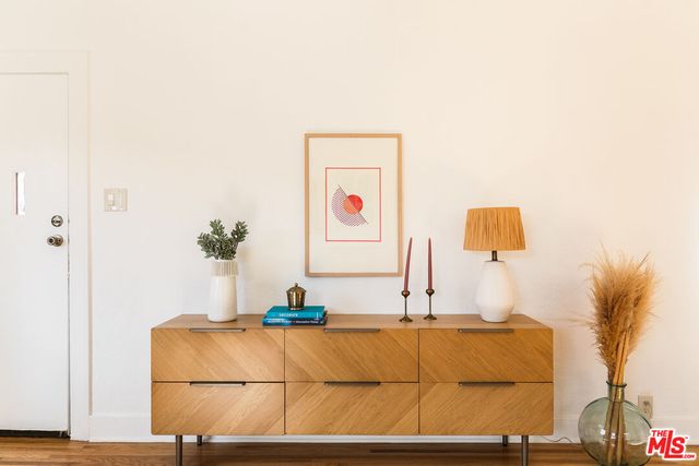 a living room with a couch and a potted plant