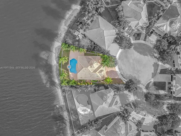 a front view of a house with a garden and a tree