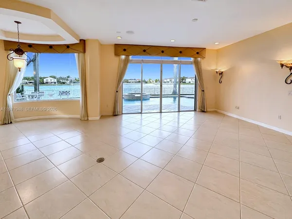 an empty room with windows and outdoor view