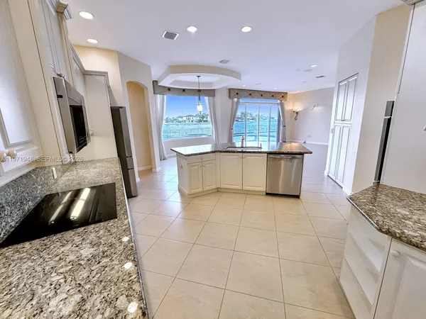a large spacious bathroom with a tub sink and mirror
