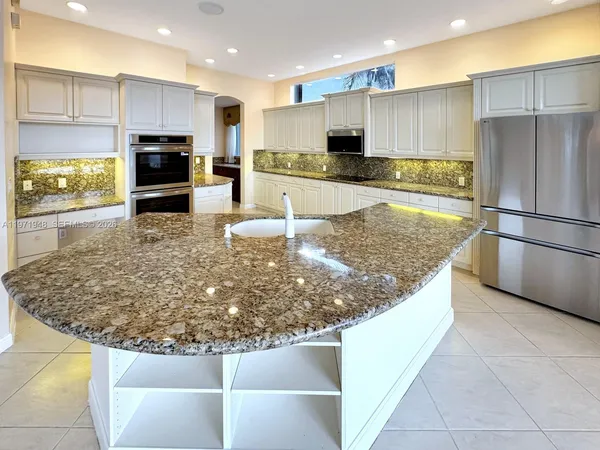 a bathroom with a tub and a painting on the wall