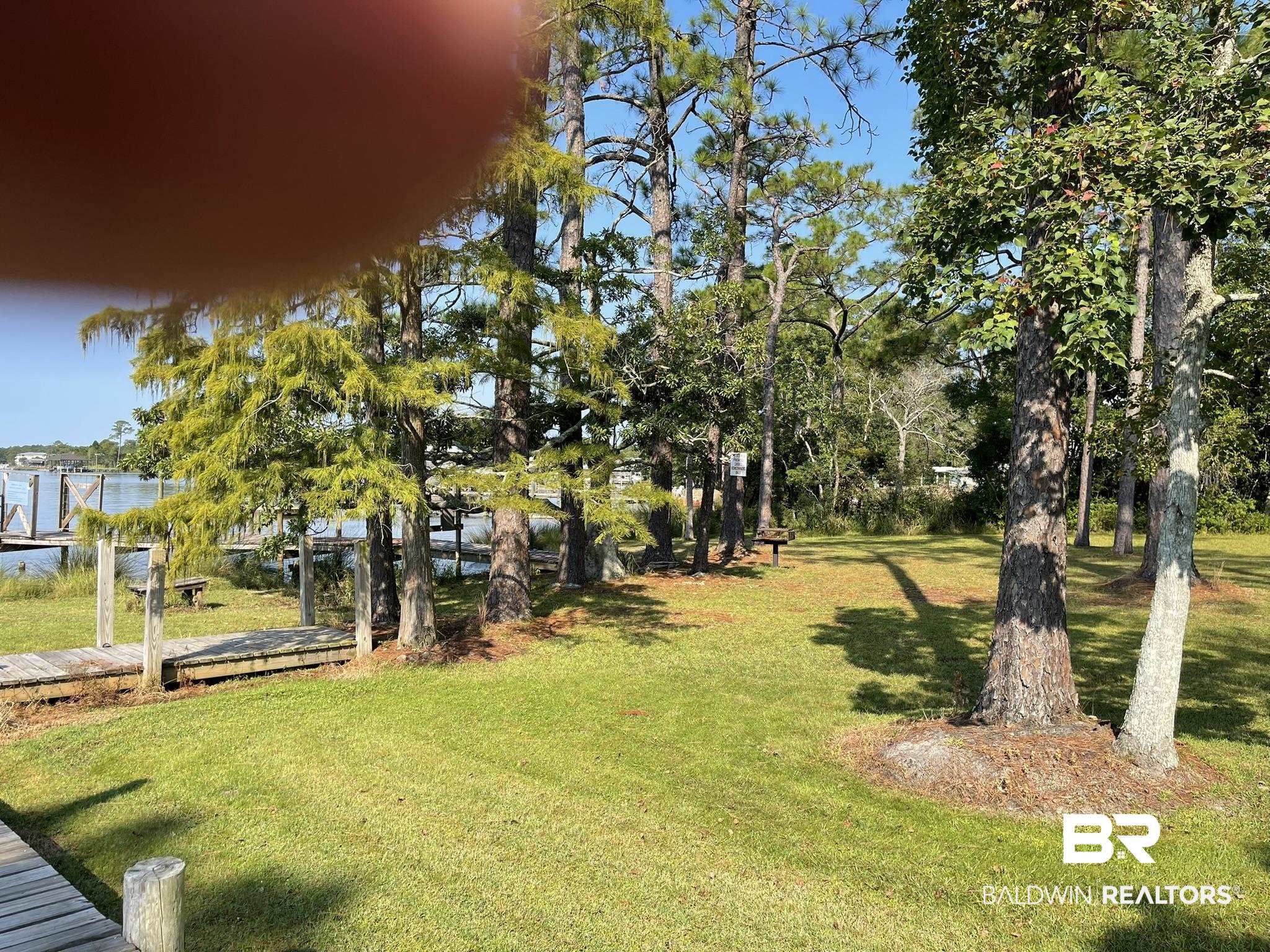 9202 Bay Pnes Road Elberta, AL 36530 - Photo 17 of 17 View of green lawn featuring a water view and a boat dock