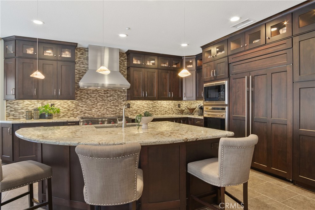 3837 Grandview Drive Brea, CA 92823 - Photo 30 of 72 a kitchen with stainless steel appliances granite countertop a kitchen island a stove a table and chairs