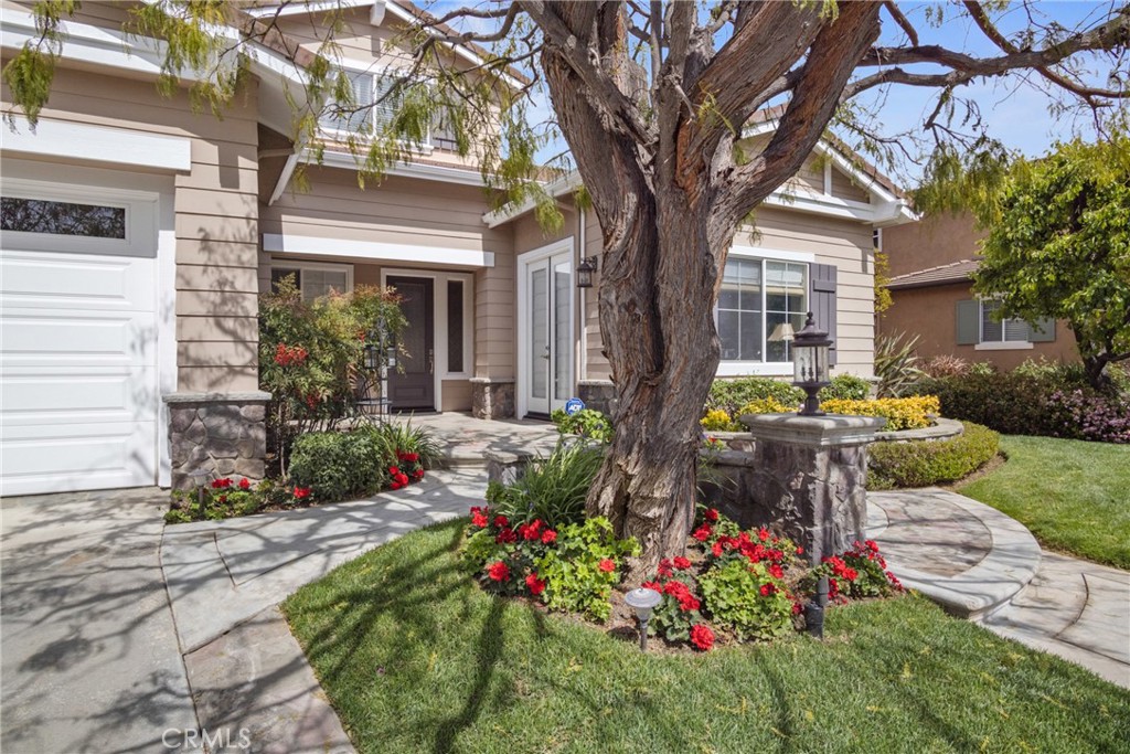 3837 Grandview Drive Brea, CA 92823 - Photo 3 of 72 a front view of a house with a yard and fountain in middle
